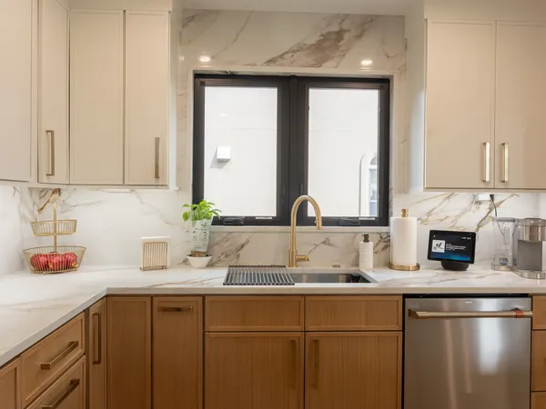 Margate Coastal Transformation — Marble backsplash and brass fixtures